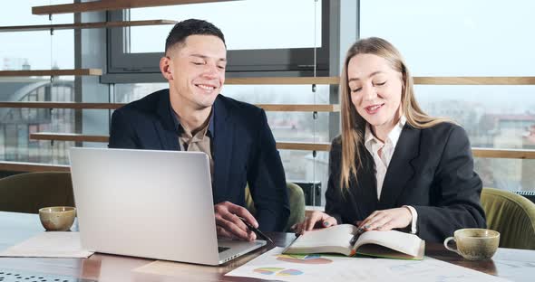 Man and a Woman Discussing Work in the Brightly Lit Modern Office. Concerned Male and Female Working alt