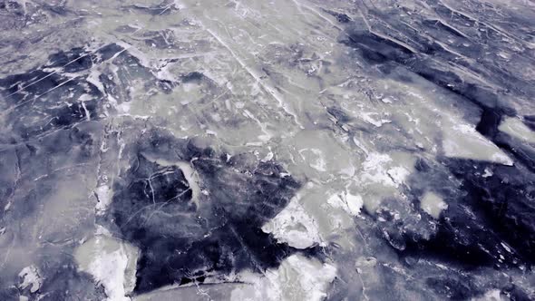 Ice covered endless sea. Beautiful landscape. Panoramic aerial view. Flying away slowly