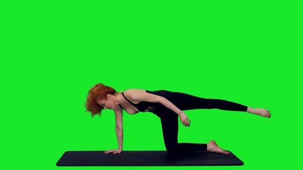 Slim Athletic Female Practicing Yoga Against Green Screen