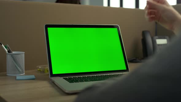 Businessman Typing on Laptop with Green Screen alt