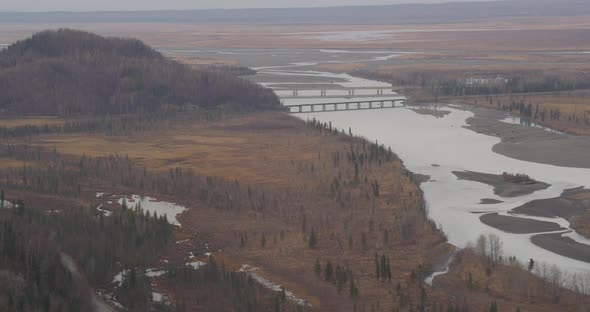 Aerial helicopter shot of Alaksan wilderness at dusk, forest and trees, drone footage alt