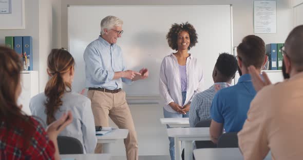 Applauding Students and Teacher Congratulating Their Groupmate After Speech in Classroom alt