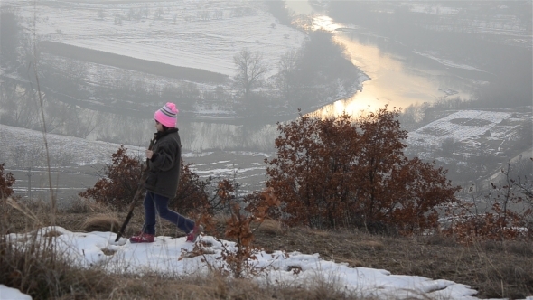 Little Girl Walking on a Hill