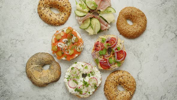 Bagel Sandwiches with Various Toppings, Salmon, Cottage Cheese, Hummus, Ham, Radish and Fresh Herbs alt
