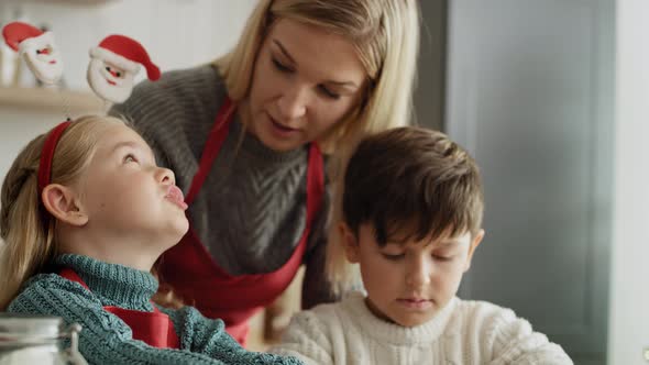 Tilt down video of family during Christmas baking. Shot with RED helium camera in 8K alt