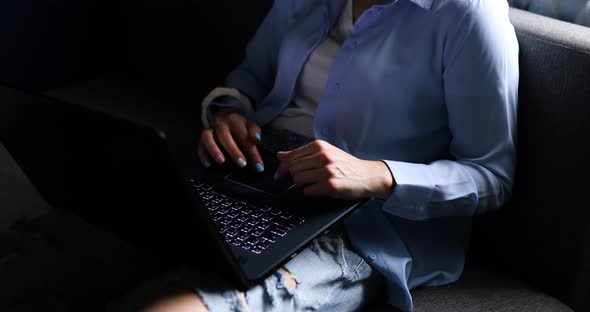 Woman Using Search a Laptop on a Sofa at Home Checking Social Media alt