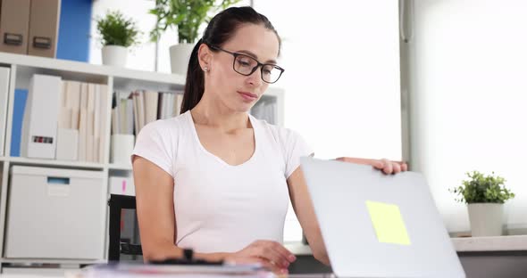 Tired Woman Closing Laptop and Taking Off Glasses in Office  Movie alt