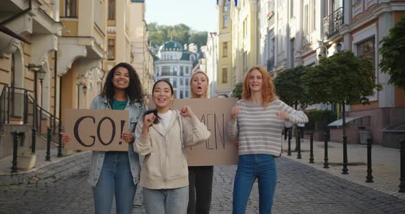Outdoor Portrait of Women Activists Protest with Go Woman Posters alt