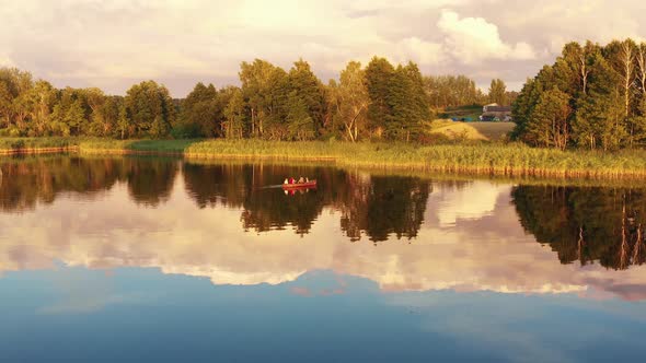 Drone Flying Towards Happy Family with Children Enjoying Row Boat Ride Together on Incredible Summer alt