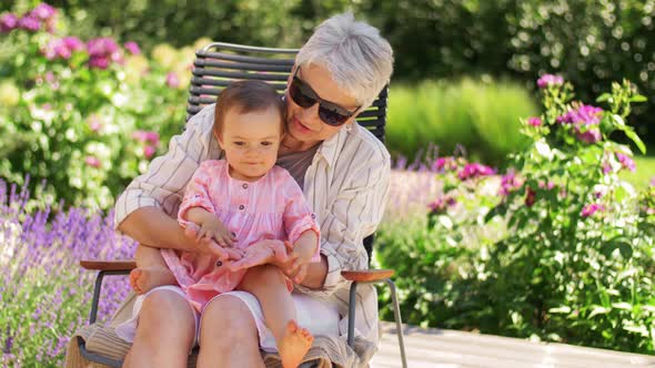 Happy Grandmother and Baby Granddaughter at Garden alt