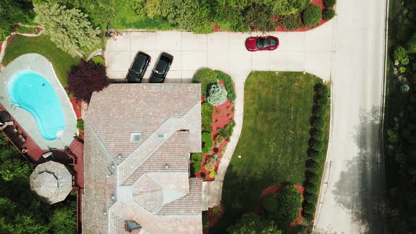 luxury car parking at a luxury residential house with personal swimming pool cinematic aerial view i alt