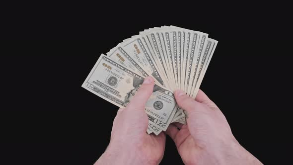Male Hands Holding a Fan of a Lot of 20 Dollar Bills with Alpha Channel alt