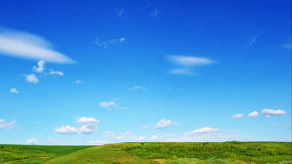 Sky with Clouds Over a Green Meadow Time-Lapse
