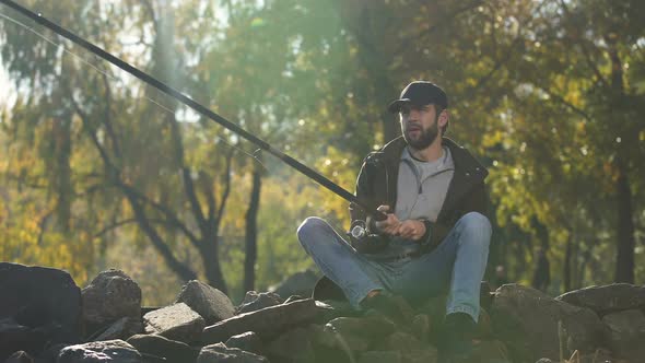 Upset Fisherman Fishing on River Bank alt