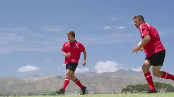 Rugby players having match on field alt