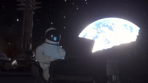 Astronaut Works on His Science Laptop in a Space Colony on One of the Planets alt