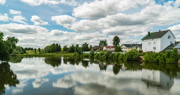 Village Landscape with a Small Lake, Time Lapse of Clouds Reflected in the Water, Beautiful Summer alt