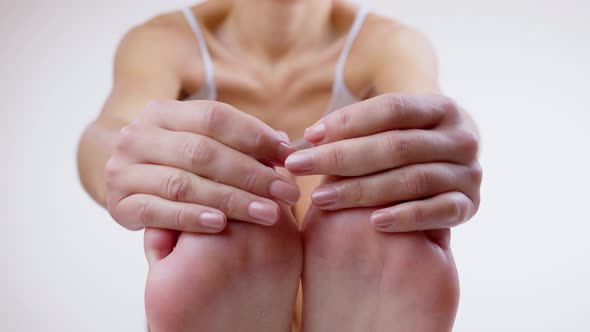 Woman Applying Cosmetic Foot Cream