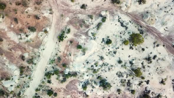 Drone moving forward looking straight down showing Australian Outback with iconic red, orange and wh alt