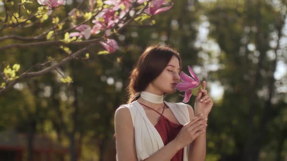 Spring Beauty Portrait of a Woman with Flower Outdoors alt