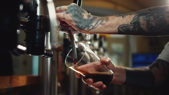 Barman Pouring Nitrogen Beer Into Glass Closeup alt