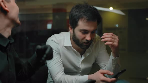 Bearded Man Explains to a Barber His Future Haircut Style alt