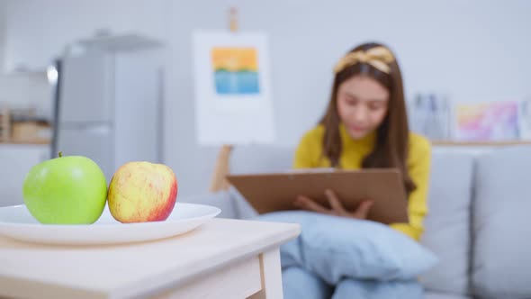 Asian young talented woman artist drawing picture on painting board. alt