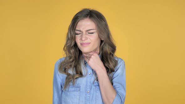 Sick Young Girl Coughing Isolated on Yellow Background alt