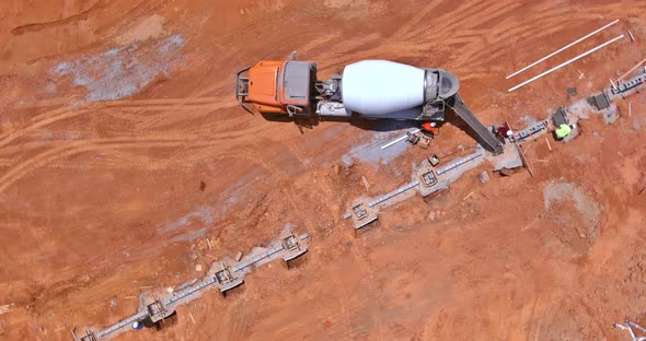 With the Help of a Concrete Mixer Truck Concrete Columns Were Poured to Construct a New House alt