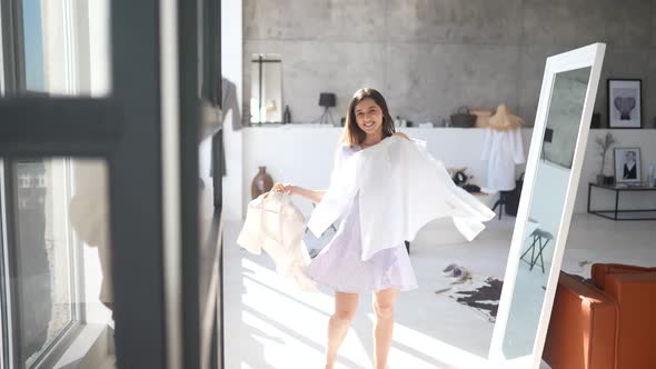 Beautiful Girl Trying Dress in Room alt
