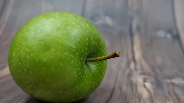 Natural Green Apple on a Wooden Background Closeup