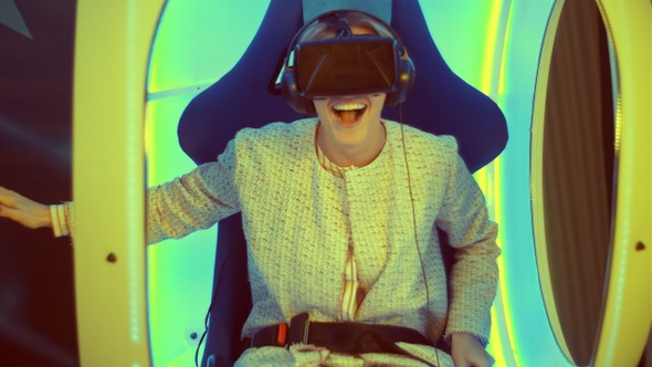 Surprised young female experiencing virtual reality for