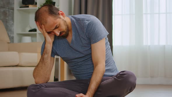 Unhappy Man Browsing on Smartphone alt