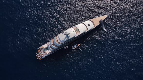 Aerial view of large super yacht and small boat. Luxury life on a super yacht.