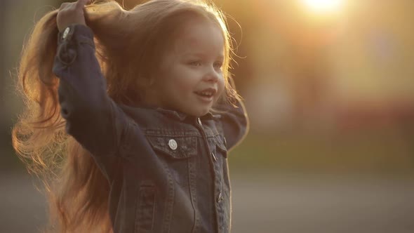 Girl Twirling and Posing with Beautiful Long Hair in Park