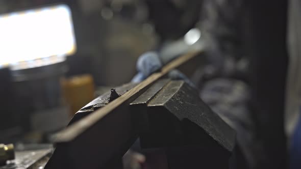 Close up from hand sending wood in bench vise