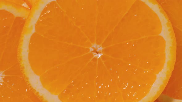 Colorful Orange Citrus Fruit Slices on Rotating Surface  Close Up Top View