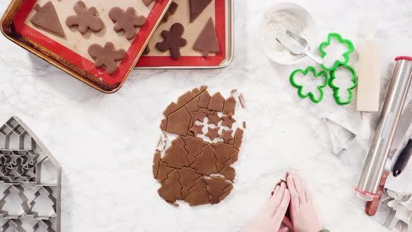 Flat lay. Step by step. Cutting out shapes with Christmas cookies cutter from gingerbread cookie dou alt