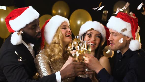 Cheerful Friends in Santa Hats Clinking Glasses, New Year Corporate Party alt
