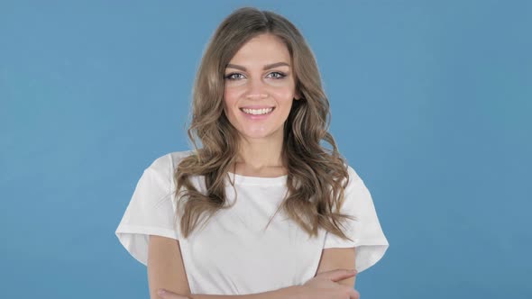 Smiling Young Girl Isolated on Blue Background alt