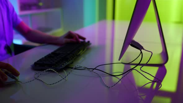 Closeup Neon Hands Using Gaming Equipment at Home alt