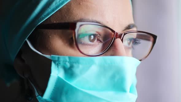 Woman doctor wearing a surgical mask and glasses