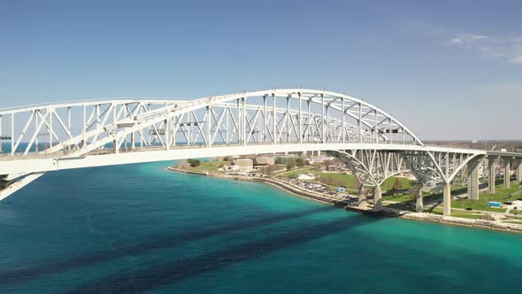 Blue Water Bridge connecting Port Huron, Michigan USA and Sarnia, Ontario Canada with droneing up. alt