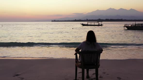 Beautiful ladies sunbathing on paradise island beach voyage by blue lagoon and white sandy backgroun alt