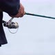 Faceless Man Twists Spinning Rod to Catch Fish - VideoHive Item for Sale
