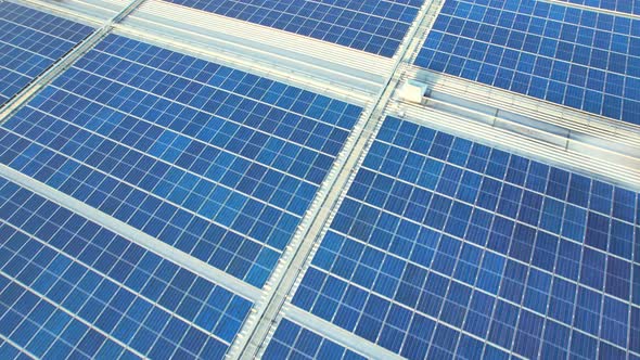 Aerial cinematic view of a solar panel on mall roof top alt