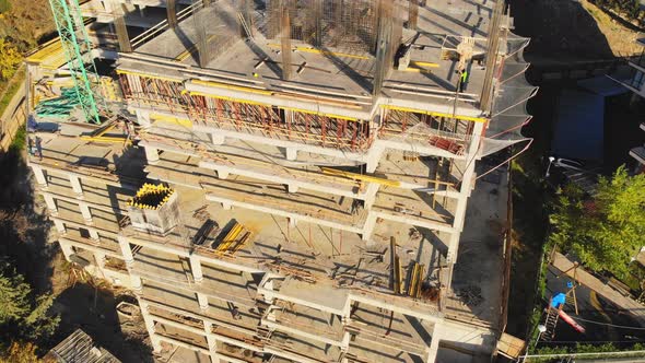 Worker Aware Of Heavy Lifts Over Head In Construction Site alt