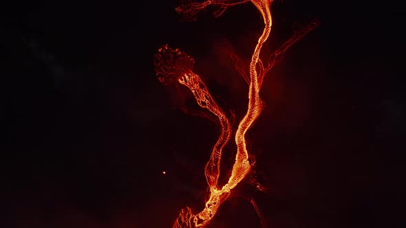 Aerial Birds Eye Overhead Top Down Panning View of Flowing Hot Lava Stream After Volcano Eruption alt