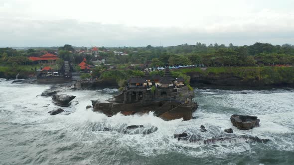 Empty Tanah Lot Temple on Dark Rocky Cliff at Sea During Dangerous Weather alt
