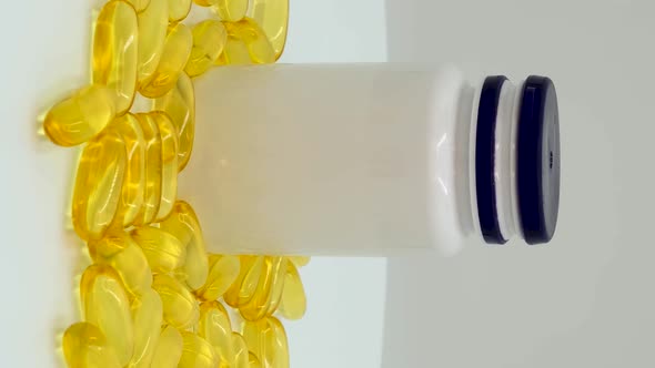 Vertical orientation video: Omega 3 (fish oil). Organic supplements vitamins yellow capsules alt